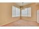 Bright living room featuring neutral carpet, pendant lighting, and large windows with views at 43 E Agate Ave # 305, Las Vegas, NV 89123