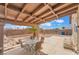 Backyard featuring covered patio with patio table and chairs and views of palm trees and blue sky at 4712 Belshire Dr, Las Vegas, NV 89147