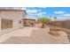 The backyard features a covered patio, landscaping with a palm tree, and a rock border at 4712 Belshire Dr, Las Vegas, NV 89147