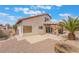 Backyard featuring a covered patio, gravel landscaping with a palm tree, and a rock border at 4712 Belshire Dr, Las Vegas, NV 89147