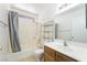 Bathroom featuring a shower-tub combo with gray curtain, a toilet, and a vanity sink at 4712 Belshire Dr, Las Vegas, NV 89147