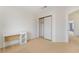 Bedroom with carpet flooring, a desk, and a closet with sliding doors at 4712 Belshire Dr, Las Vegas, NV 89147