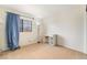 Well-lit bedroom features a window with curtains and a white desk at 4712 Belshire Dr, Las Vegas, NV 89147