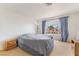 Bedroom with a bed and curtains, capturing an airy and comfortable atmosphere at 4712 Belshire Dr, Las Vegas, NV 89147