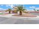 Charming two-story home with a lush palm tree, a driveway, and a terracotta-tiled roof at 4712 Belshire Dr, Las Vegas, NV 89147