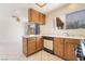 Kitchen with wooden cabinetry and modern appliances, leading into a living area at 4712 Belshire Dr, Las Vegas, NV 89147