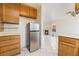 Kitchen leading into the living room with fireplace, showcasing a stainless steel refrigerator at 4712 Belshire Dr, Las Vegas, NV 89147