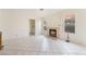 Cozy living room with fireplace, tiled floors, and natural light from the windows at 4712 Belshire Dr, Las Vegas, NV 89147