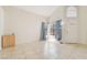 Bright living room with high ceiling, tiled floors, and natural light from the large windows at 4712 Belshire Dr, Las Vegas, NV 89147
