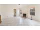 Cozy living room with fireplace, tiled floors, and access to the laundry room at 4712 Belshire Dr, Las Vegas, NV 89147