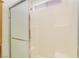 Shower featuring sliding glass doors and white tiled walls, showcasing a clean and functional bathroom space at 4712 Belshire Dr, Las Vegas, NV 89147