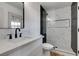 Modern bathroom featuring a luxurious walk-in shower with sleek black accents and a stylish vanity with black hardware at 4855 San Sebastian Ave, Las Vegas, NV 89121