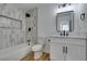 Bright bathroom features white vanity with black hardware and decorative tile shower with built-in niche at 4855 San Sebastian Ave, Las Vegas, NV 89121