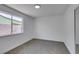 Clean bedroom with neutral carpet, white walls, and bright window at 4855 San Sebastian Ave, Las Vegas, NV 89121