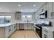 Updated kitchen features modern appliances, white cabinets and countertops, with a view to the backyard at 4855 San Sebastian Ave, Las Vegas, NV 89121