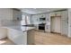 Modern kitchen featuring white cabinets, stainless steel appliances, and light wood flooring at 4855 San Sebastian Ave, Las Vegas, NV 89121