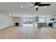 Bright open-concept living space with modern fireplace, and light-filled kitchen with modern fixtures at 4855 San Sebastian Ave, Las Vegas, NV 89121
