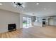 Living room area with fireplace, light wood floors and kitchen access at 4855 San Sebastian Ave, Las Vegas, NV 89121