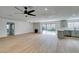 Open living room and kitchen with light wood floors and access to backyard at 4855 San Sebastian Ave, Las Vegas, NV 89121