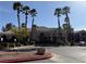 Community clubhouse showcasing professional landscaping, mature palm trees, and ample parking at 5055 W Hacienda Ave # 2175, Las Vegas, NV 89118