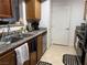 Galley kitchen has stainless appliances, wood cabinets, and granite counters at 5055 W Hacienda Ave # 2175, Las Vegas, NV 89118