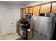 This updated kitchen features stainless steel appliances and wood cabinets at 5055 W Hacienda Ave # 2175, Las Vegas, NV 89118