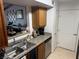 This kitchen features stainless sink, gray granite counters, and wood cabinets at 5055 W Hacienda Ave # 2175, Las Vegas, NV 89118