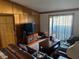 Cozy living room with a wooden accent wall, leather couches, and sliding glass doors leading to the outside at 5055 W Hacienda Ave # 2175, Las Vegas, NV 89118