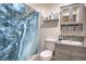 Well-lit bathroom with a vanity, granite countertop, and a marble-patterned shower curtain at 5093 Sun Valley Dr, Las Vegas, NV 89122