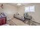 Comfortable bedroom featuring a window for natural light and a striped chair at 5093 Sun Valley Dr, Las Vegas, NV 89122