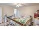 Cozy bedroom with a ceiling fan, neutral walls, and wood-look flooring at 5093 Sun Valley Dr, Las Vegas, NV 89122