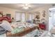 Bright bedroom featuring a ceiling fan, mirrored closet, and neutral-toned walls at 5093 Sun Valley Dr, Las Vegas, NV 89122