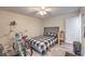 Bright bedroom featuring a ceiling fan, wood-look floors, and a stylish headboard at 5093 Sun Valley Dr, Las Vegas, NV 89122