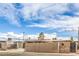 Street view of a home featuring a long driveway and secure wooden fence, ensuring privacy at 5093 Sun Valley Dr, Las Vegas, NV 89122