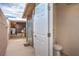 Exterior view featuring an outdoor shower, restroom, and utility access on the side of the house at 5093 Sun Valley Dr, Las Vegas, NV 89122