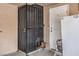 Exterior view showcasing a security gate, entrance door, and refrigerator, enhancing security and utility at 5093 Sun Valley Dr, Las Vegas, NV 89122