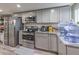 Well-lit kitchen with stainless steel appliances, gray cabinetry, and granite countertops at 5093 Sun Valley Dr, Las Vegas, NV 89122