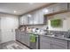 Kitchen with stainless steel dishwasher, gray cabinets, and granite countertops near doorway at 5093 Sun Valley Dr, Las Vegas, NV 89122