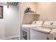 Convenient laundry area with modern, white front-load washer and dryer at 5093 Sun Valley Dr, Las Vegas, NV 89122