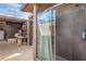 The backyard features an outdoor shower with a modern sliding glass door and grey tile at 5093 Sun Valley Dr, Las Vegas, NV 89122