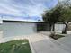 Backyard featuring a concrete patio, mature trees, and a view of the house at 524 Bedford Rd, Las Vegas, NV 89107