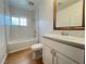 Bright bathroom with a tub, white tiling, and a vanity with a framed mirror at 524 Bedford Rd, Las Vegas, NV 89107