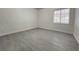 Bedroom featuring gray flooring, painted block walls and a window with blinds at 524 Bedford Rd, Las Vegas, NV 89107