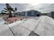 Street view of home with nice landscaping, long driveway and exterior paint at 524 Bedford Rd, Las Vegas, NV 89107