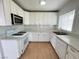 Well-lit kitchen with white cabinetry, appliances and a stainless-steel microwave at 524 Bedford Rd, Las Vegas, NV 89107