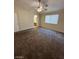 Carpeted Primary bedroom with a ceiling fan and natural light from a large window at 5433 Bridgehampton Ave, Las Vegas, NV 89130