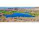 Aerial view showcasing a golf course, blue pond, mountains and serene landscapes in the distance at 6 Lilla Rosa St, Henderson, NV 89011