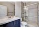 Bathroom featuring a glass enclosed shower with tile surround, single sink vanity and tile floors at 6 Lilla Rosa St, Henderson, NV 89011