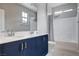 Bathroom featuring double sink vanity with blue cabinets and shower-tub combination at 6 Lilla Rosa St, Henderson, NV 89011