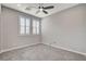 This bedroom features carpet floors, neutral walls, ceiling fan and two windows providing natural light at 6 Lilla Rosa St, Henderson, NV 89011